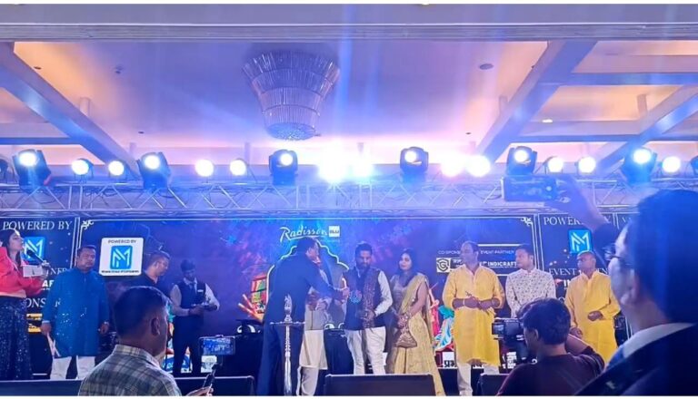 Award ceremony with group on stage under bright lights